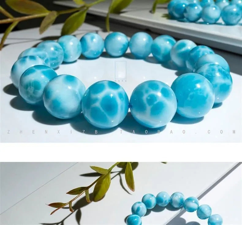 Blue Maillard-style Bodhi bracelet with a sea-pattern crystal stone and pearl accents on a wrist.