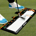 Black neoprene golf swing stance training pad on green grass