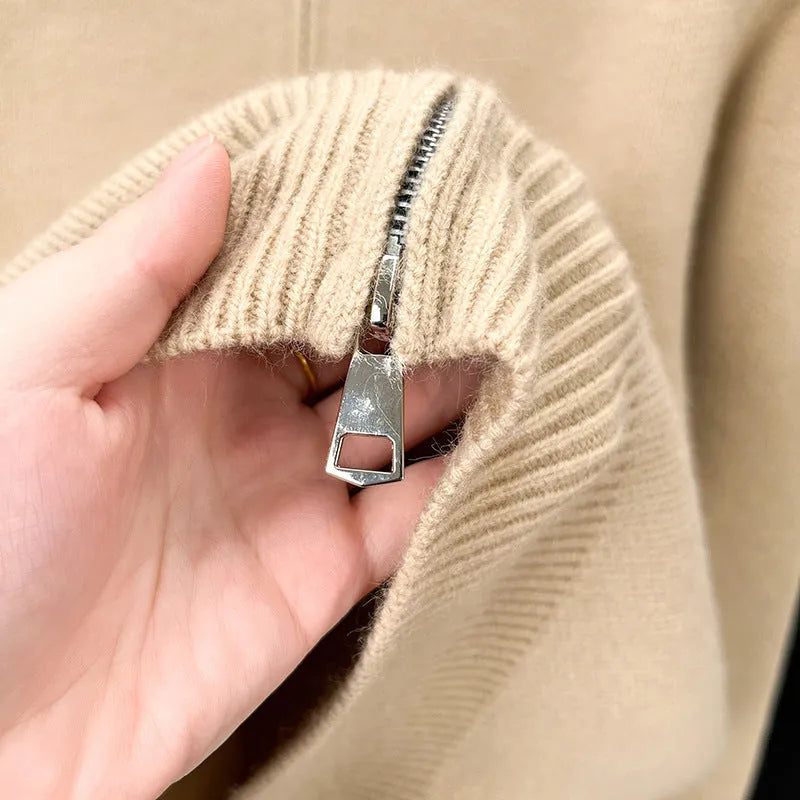 Men's black zip-up knitted cardigan with a stand collar, shown on a model.