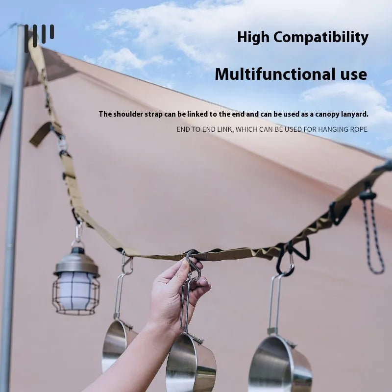 Outdoor multifunctional hanging rope clothesline storage belt in black on a green camping table