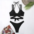 Solid colour women's bikini swimsuit on hanger showing sleeveless design and briefs style