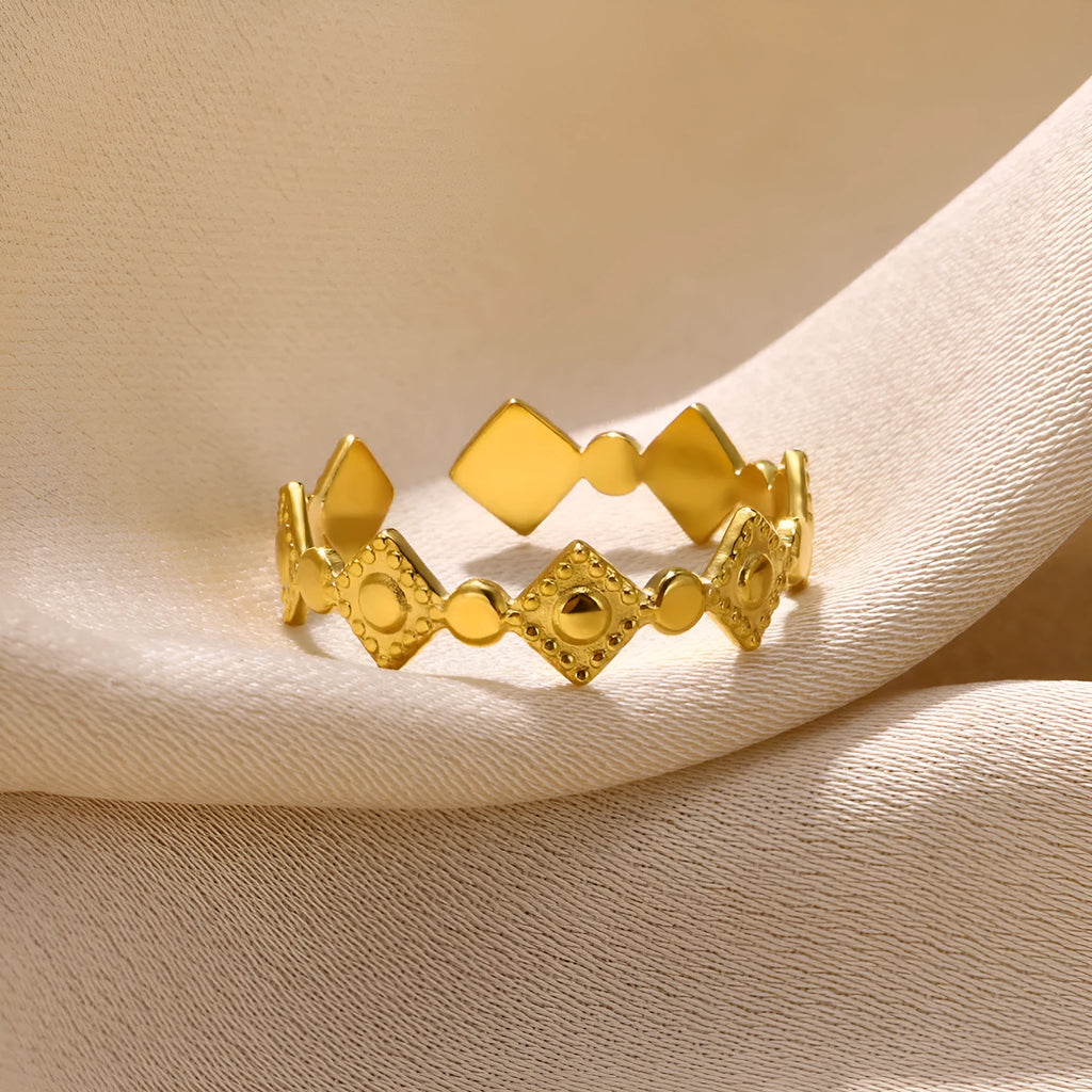 Geometric titanium steel women's ring with gold diamond setting on finger