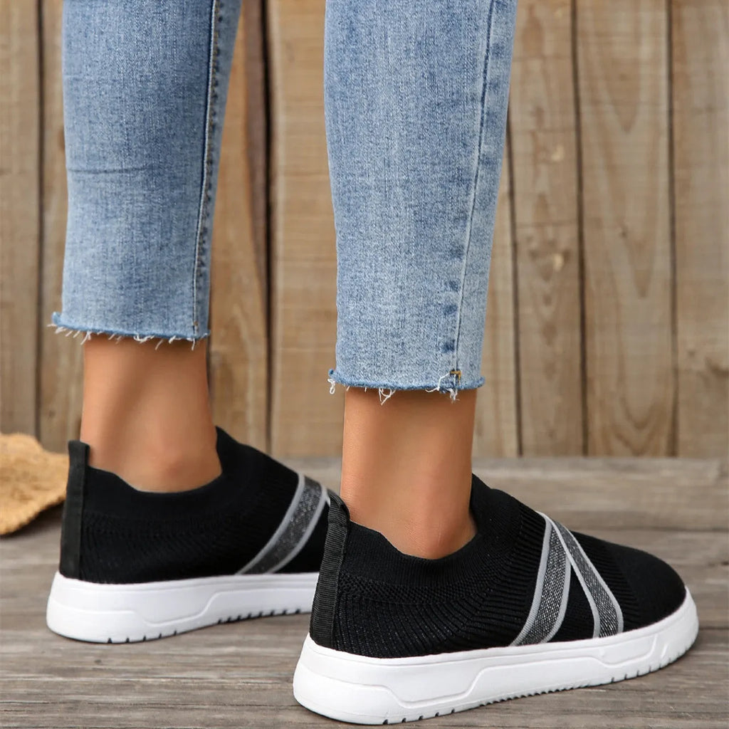 Women's black flat bottom flyknit mesh shoes with tassel detail, round toe, and rubber sole
