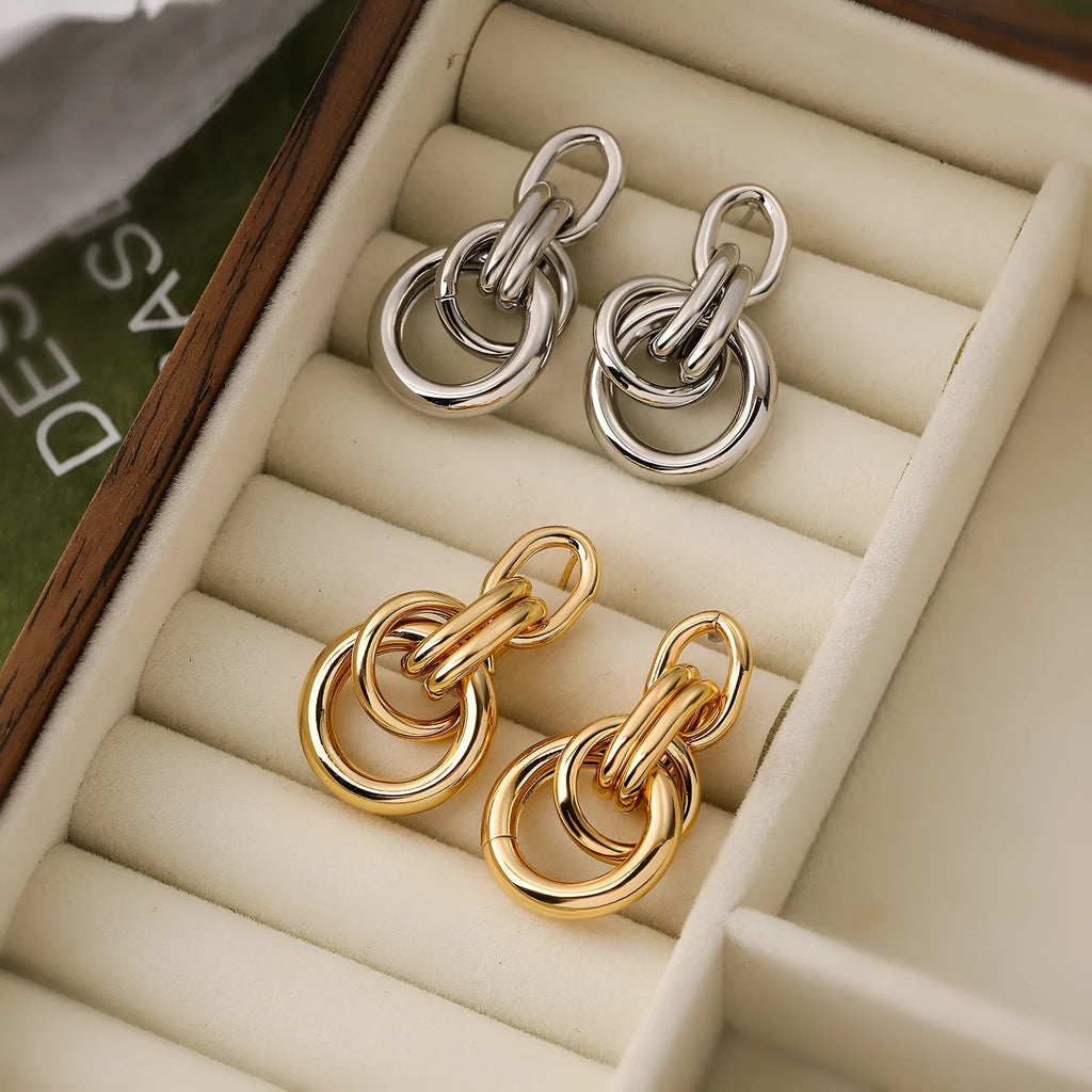 A pair of irregular geometric stud earrings in gold colour, made from copper.