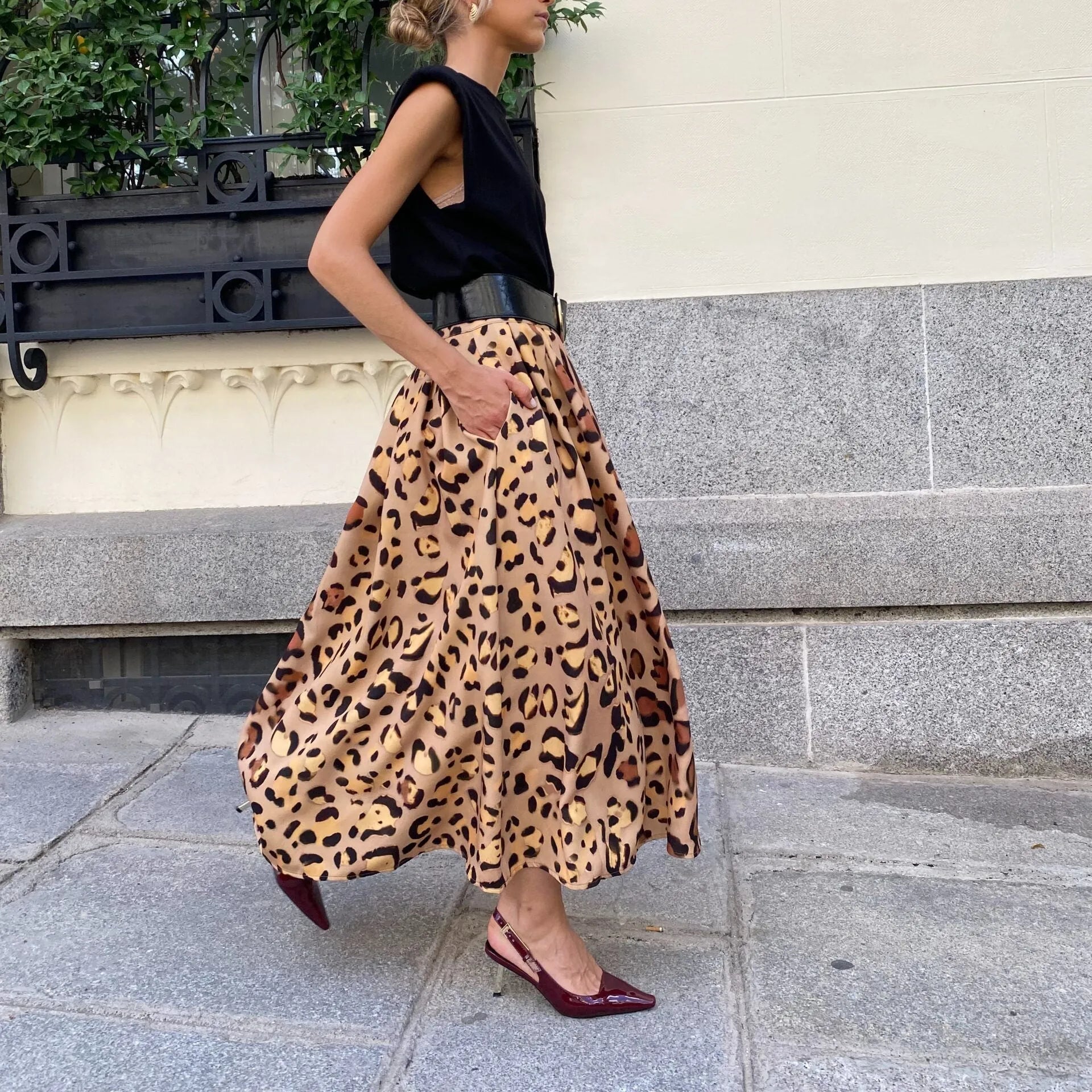 Brown leopard print women's A-line long skirt with elastic waistband laid flat.