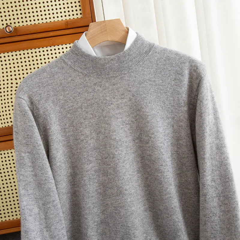 Man wearing a loose-fit half-collar wool sweater in a neutral colour, showing the knit texture and regular sleeve design.