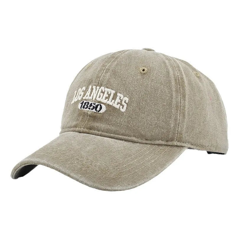 Adjustable peak cap with embroidered letters in distressed retro style, showing conical crown and 7cm brim