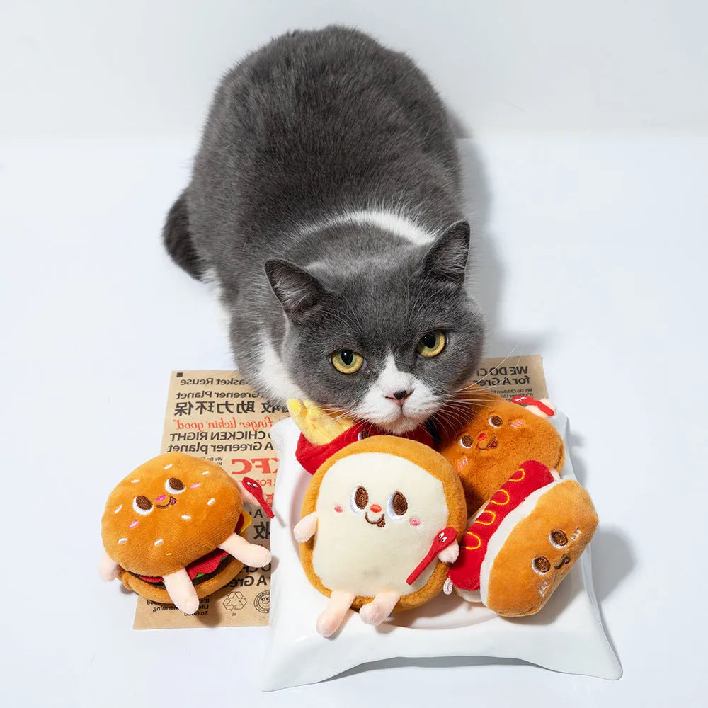 Cat mint teething toy shaped like a hamburger and chicken leg, made from soft plush fabric, on a light background.