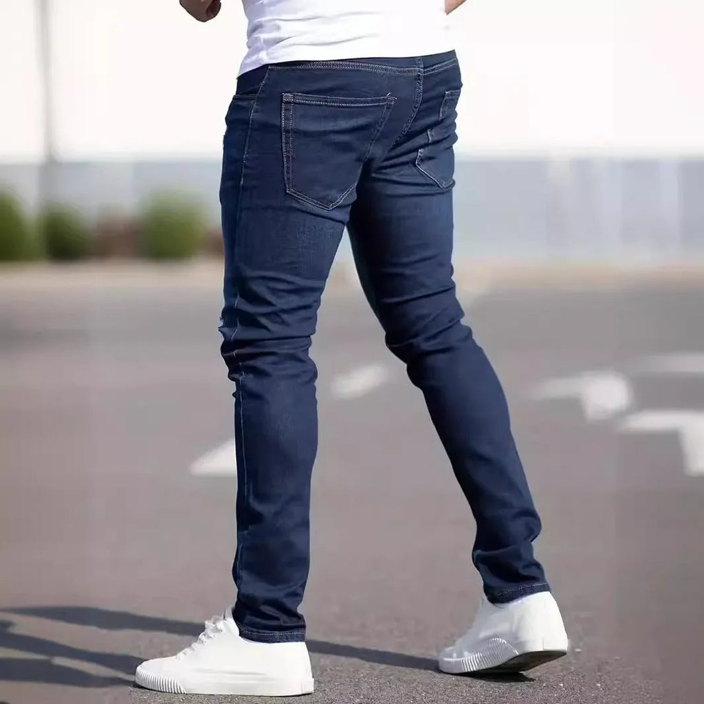 Dark blue men's slim fit cotton jeans with a skinny leg opening on a mannequin