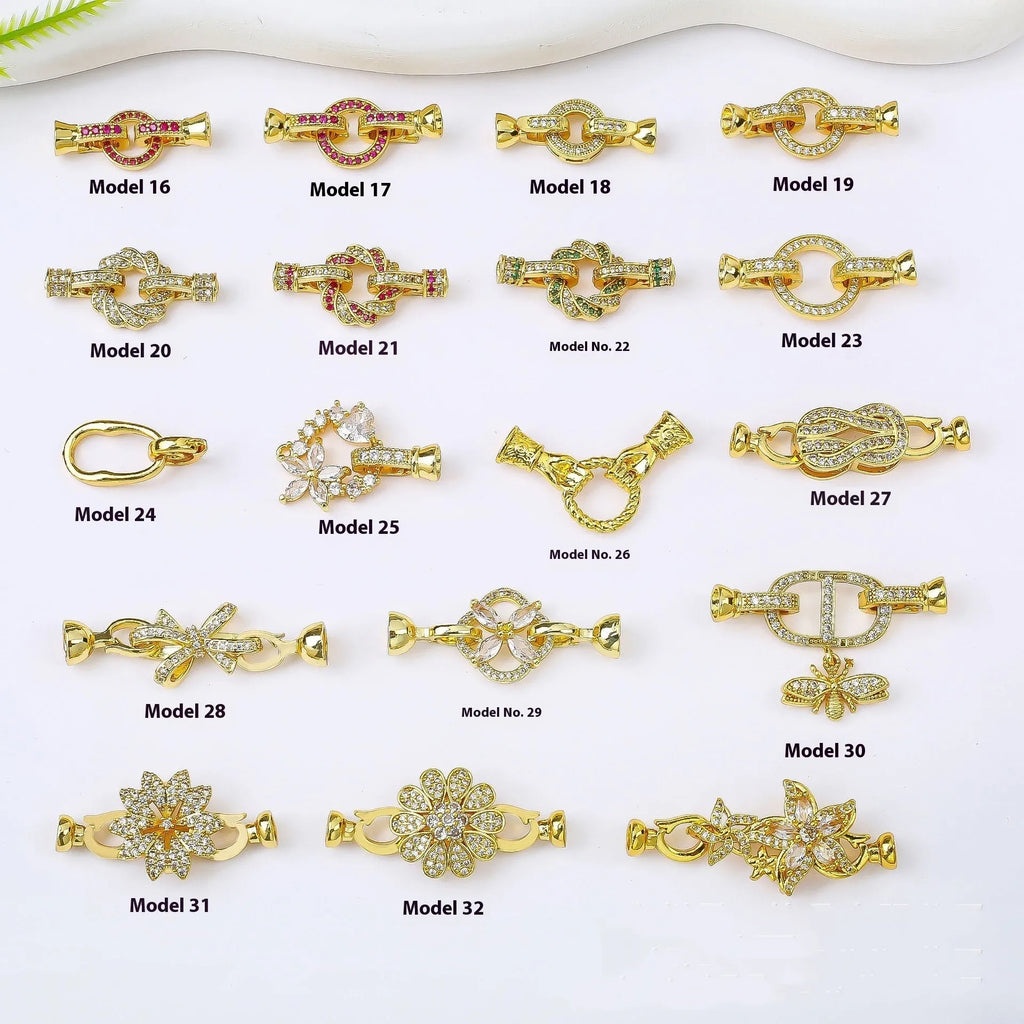 Small gold-coloured metal jewellery clasp on a white background.