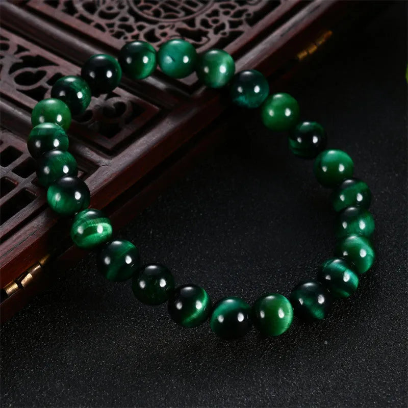 Green tiger eye stone bracelet with polished geometric beads in natural stone material