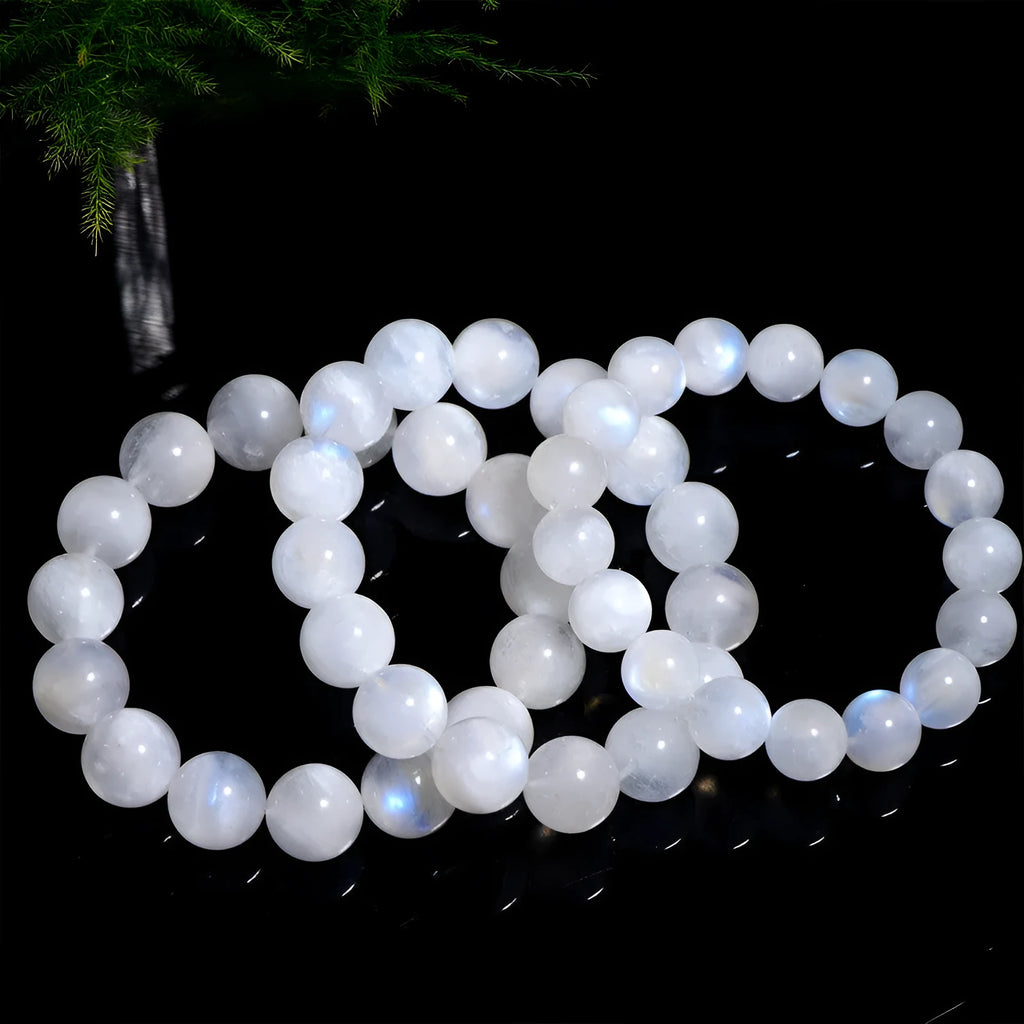 Natural blue moonstone round bead bracelet with white accents showing polished stone surface
