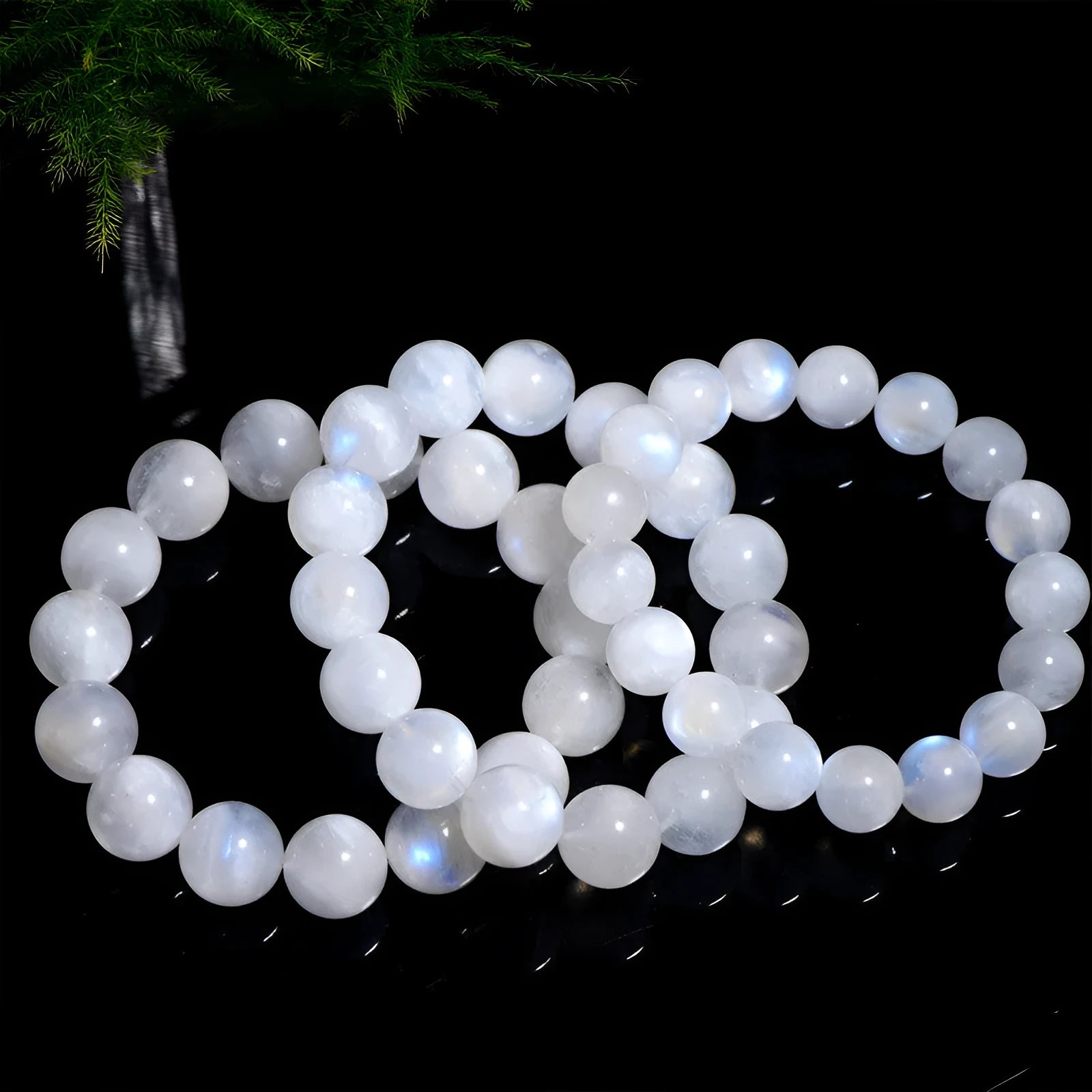 Natural blue moonstone round bead bracelet with white accents showing polished stone surface