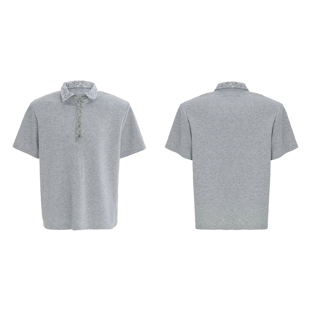 Loose fit black men's polo shirt with square collar, short sleeves, and embroidered sequin detailing.