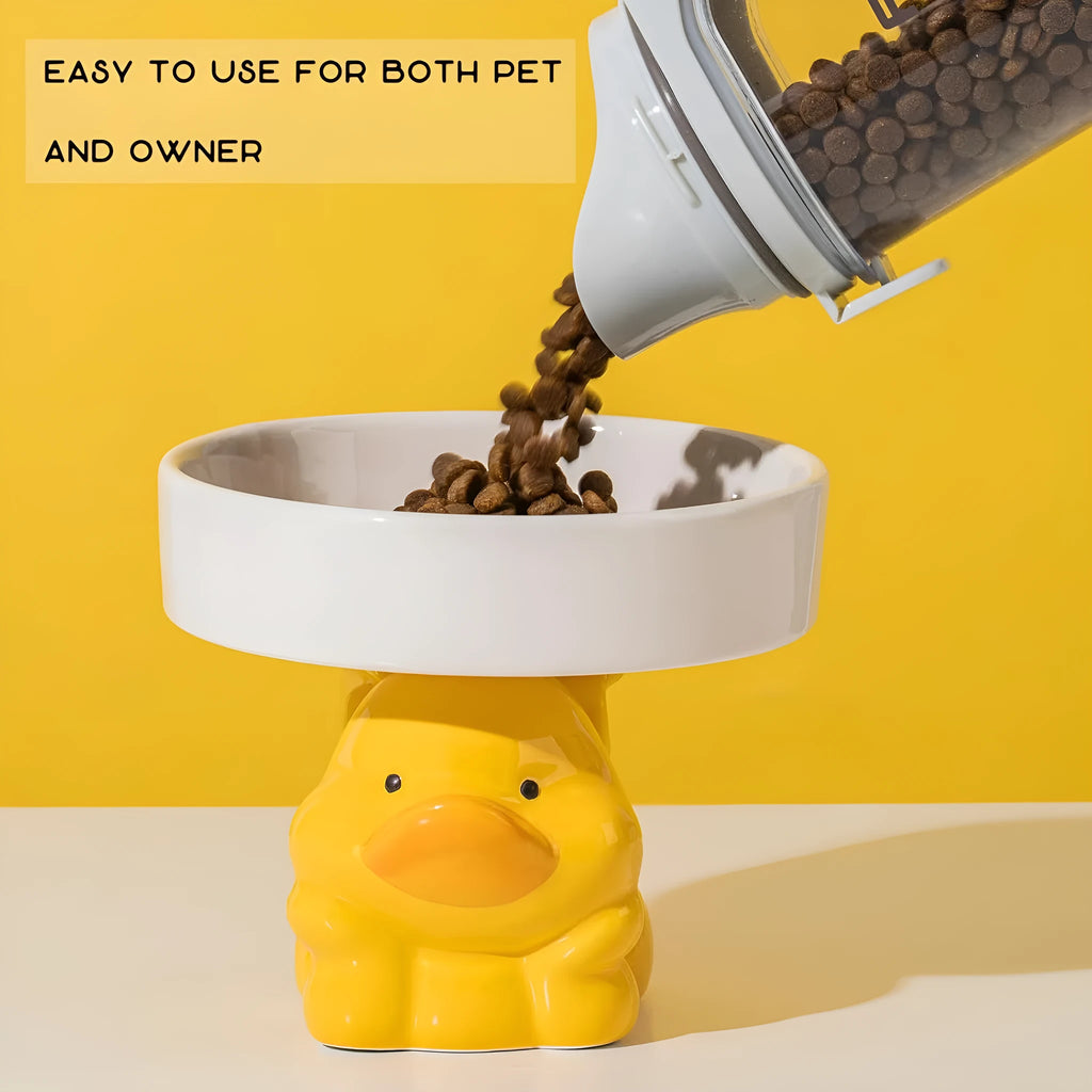 Raised ceramic cat bowl with animal design in pink, yellow, or white, showing wide feeding surface and elevated base.