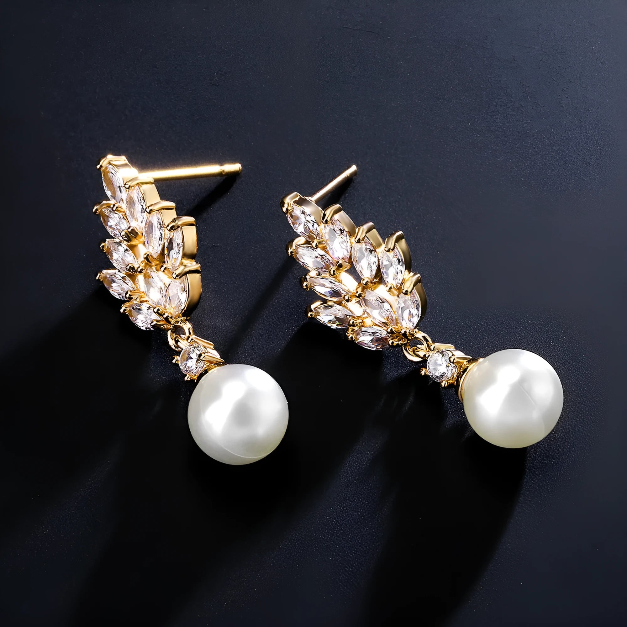 Geometric flower shaped earrings with micro inlaid zircon stones and pearl details on gold plating.