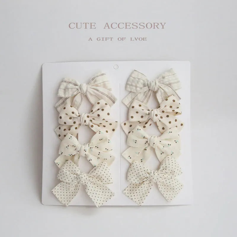 Children's fabric dovetail bow hairclips in eight colour sets including beige, blue flowers, coffee polka dot, green dots, pink, rice coffee, wine red plaid floral, and yellow