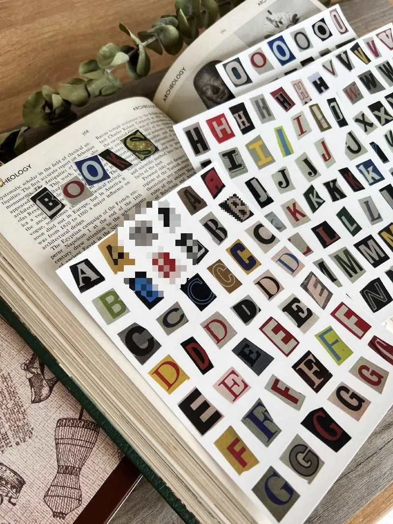 English letters and numbers symbol label stickers showing colour-coded letter sets A through E with weekly words