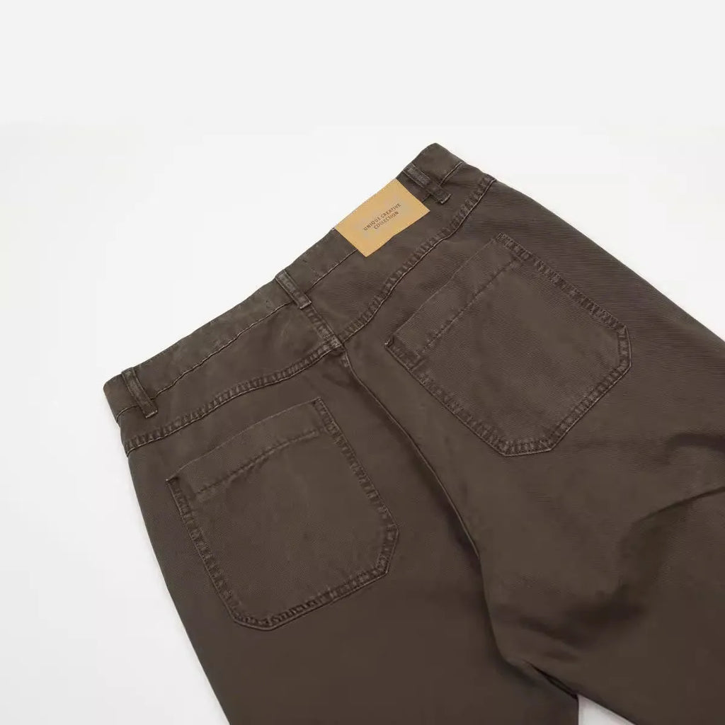 Men's brown loose straight-leg cotton trousers with a high waist and zipper fly.