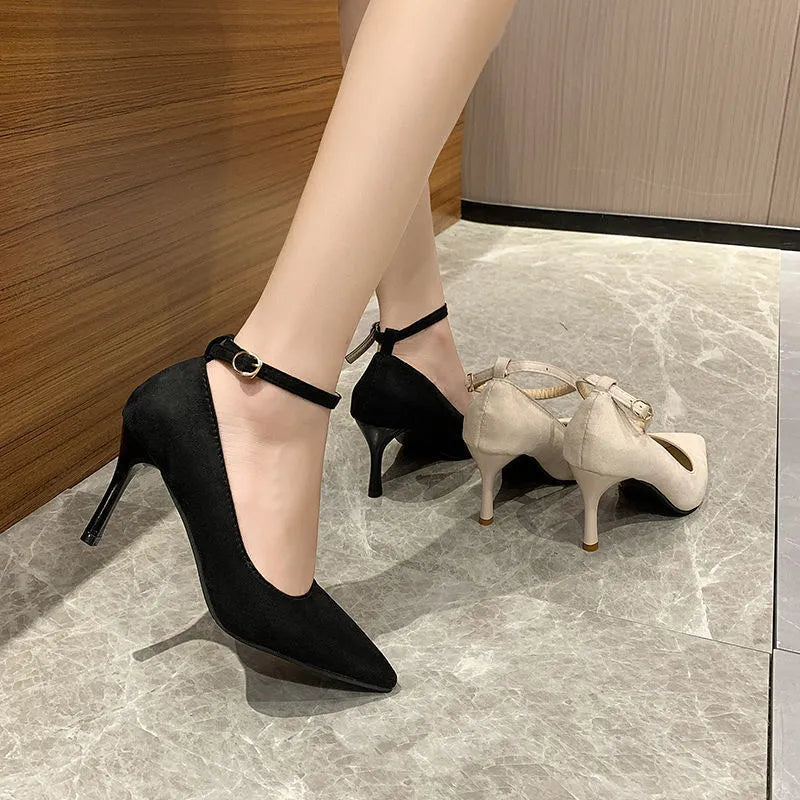 Women's black stiletto heel pumps with buckle detail showing 8cm rubber sole