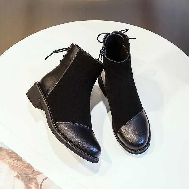 Black women's knee-high Martin boots with side zipper and round toe.