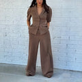 Brown men's slim fit polyester suit with trousers and long sleeve top on hanger