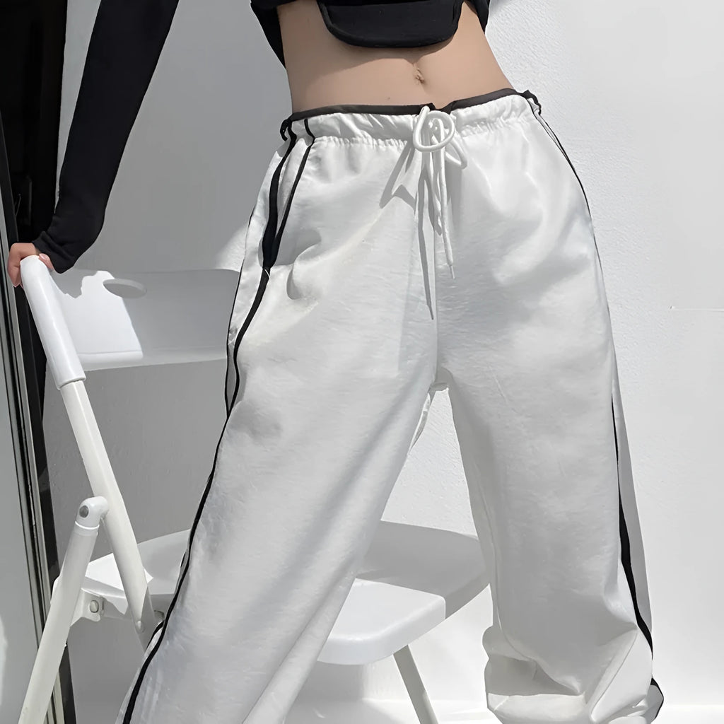 Navy blue loose straight-leg trousers with contrast detail, shown on a hanger.