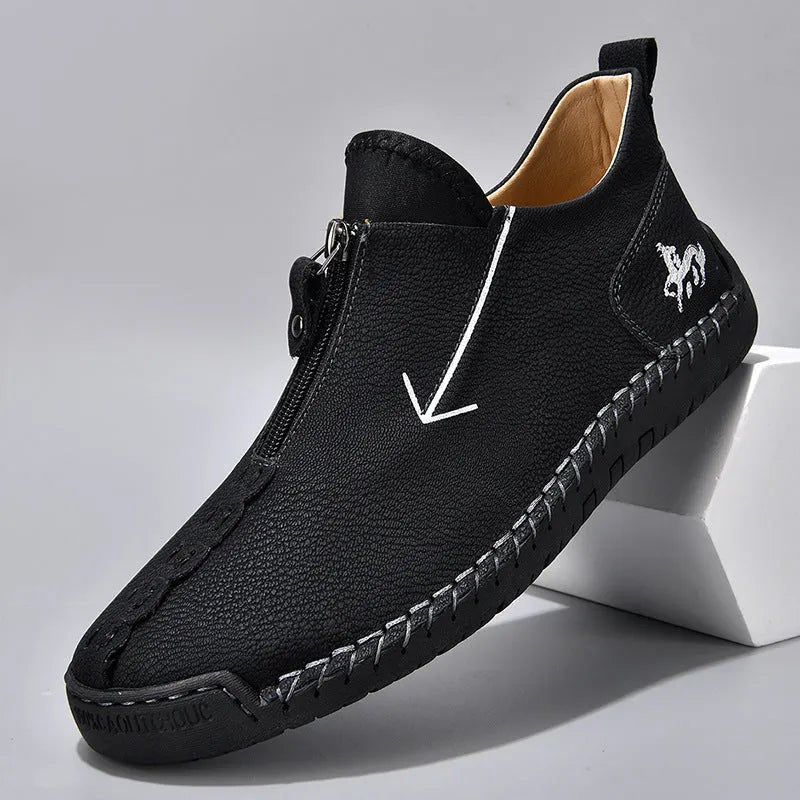 Men's black leather boots with front zipper and hand-stitched detailing on round toe