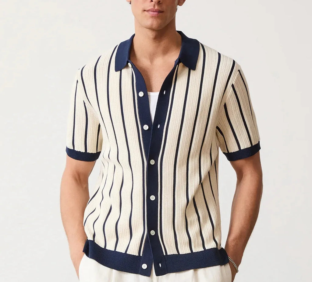 Man modelling a white short sleeve knitted top with asymmetric stripes and a lapel collar.