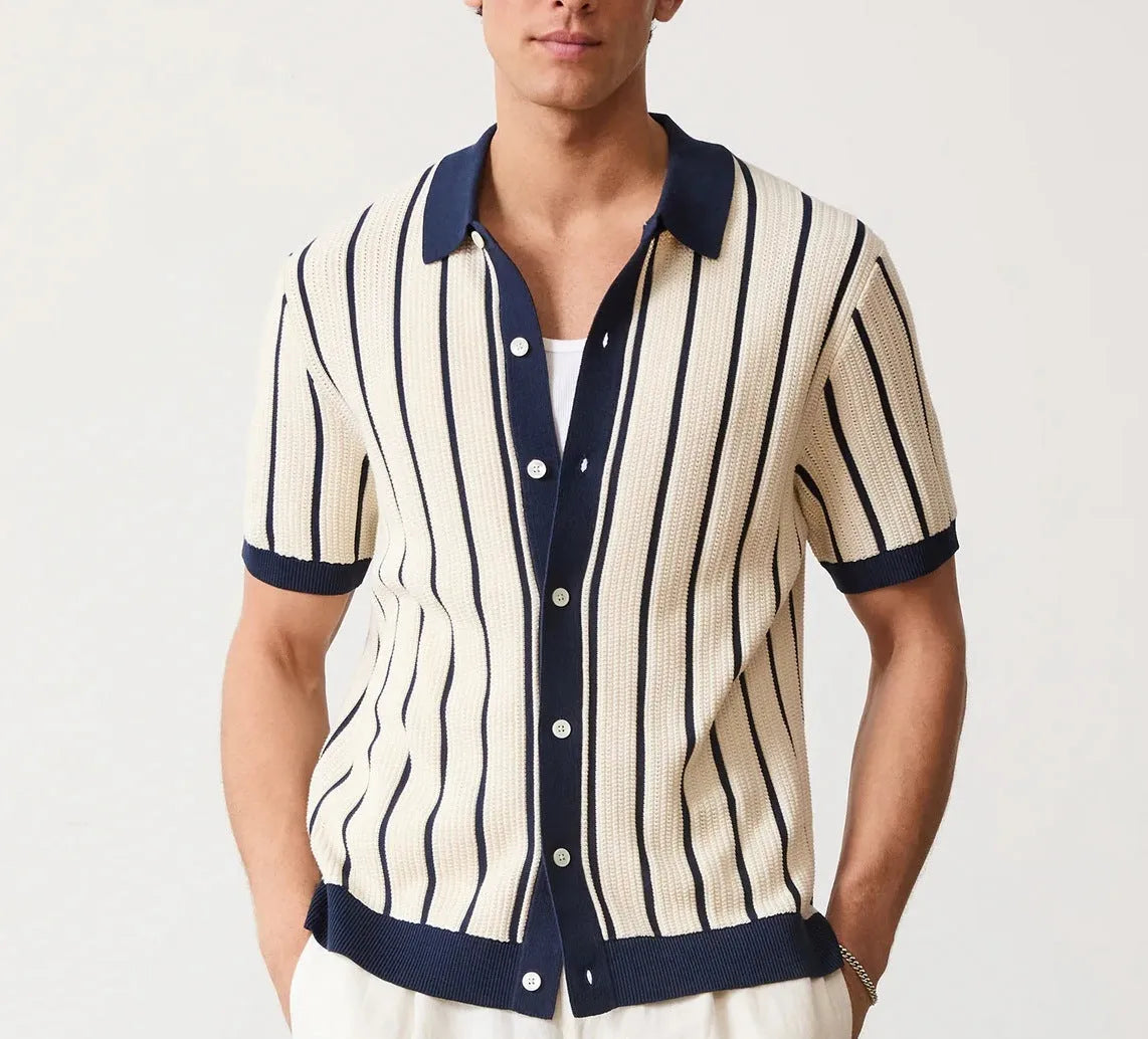 Man modelling a white short sleeve knitted top with asymmetric stripes and a lapel collar.