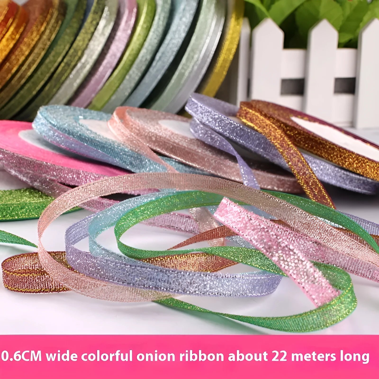 Roll of 0.6cm wide coloured polyester gift ribbon showing multiple colour options including metallic and fluorescent.