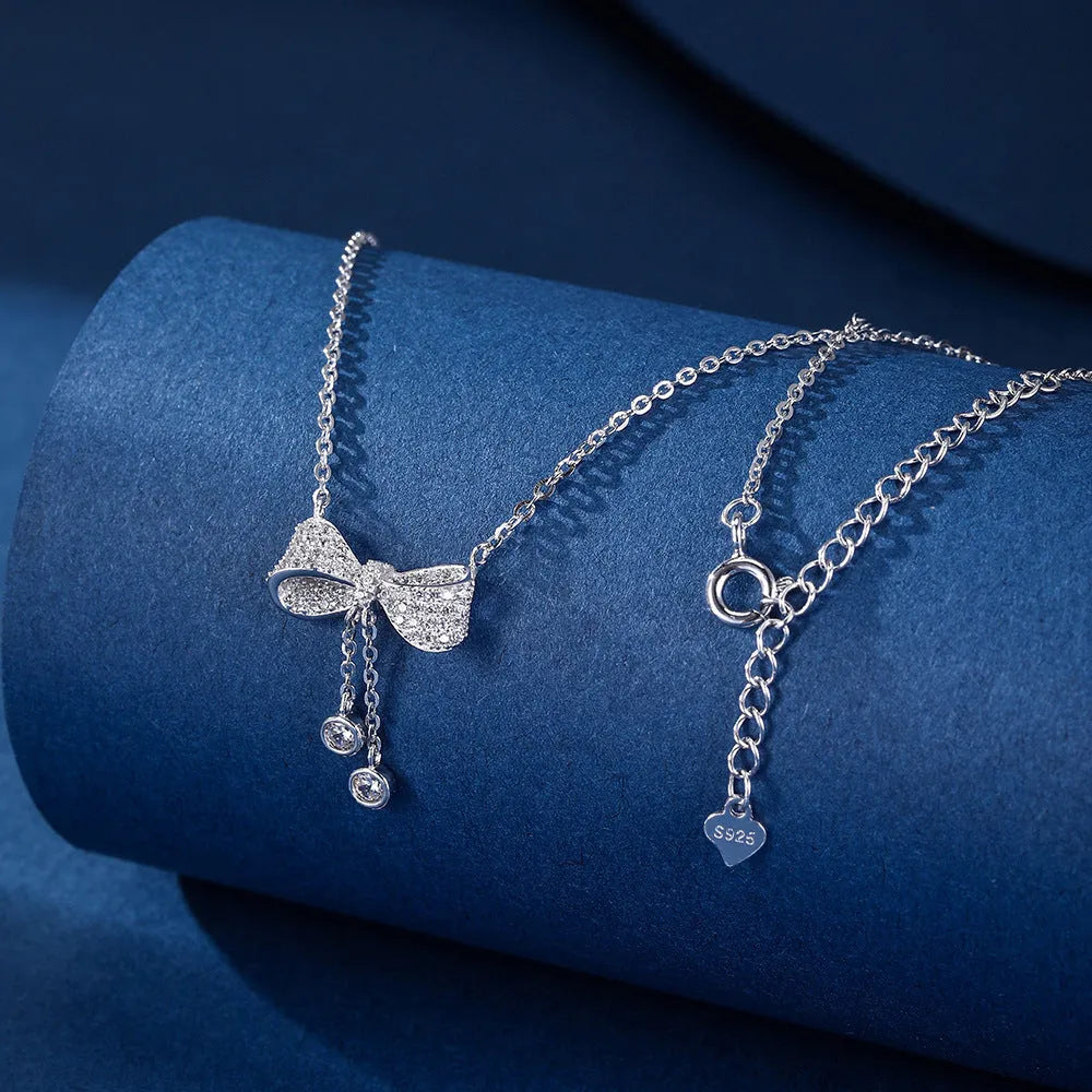 925 sterling silver necklace with a bow pendant on a silver O-ring chain.