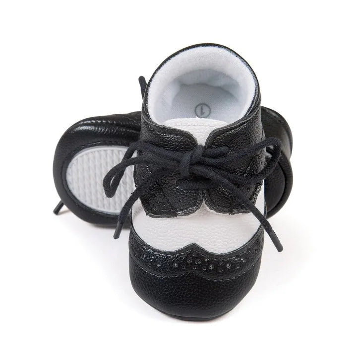 Vintage style baby shoes with soft soles in black synthetic leather