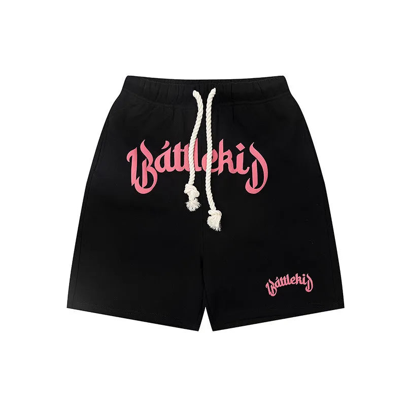 Loose-fit cotton blend cropped shorts in black, shown in a casual streetwear style.