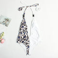 Women's leopard print one-piece bandage swimsuit with buckle detail and backless design.