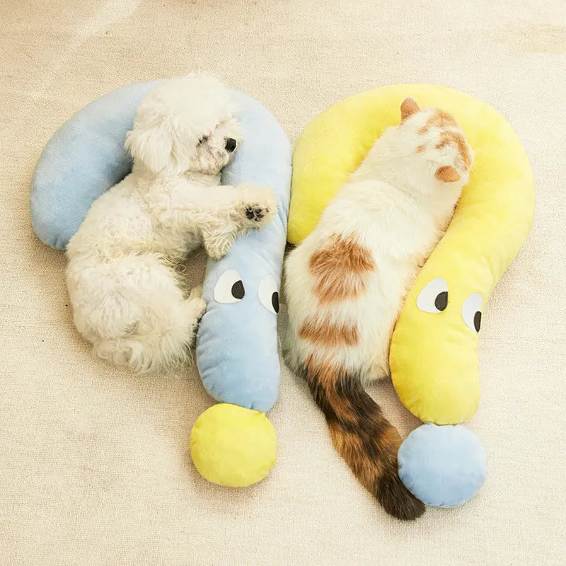 Blue rectangular pet sleeping cushion for cats and dogs on a wooden floor.