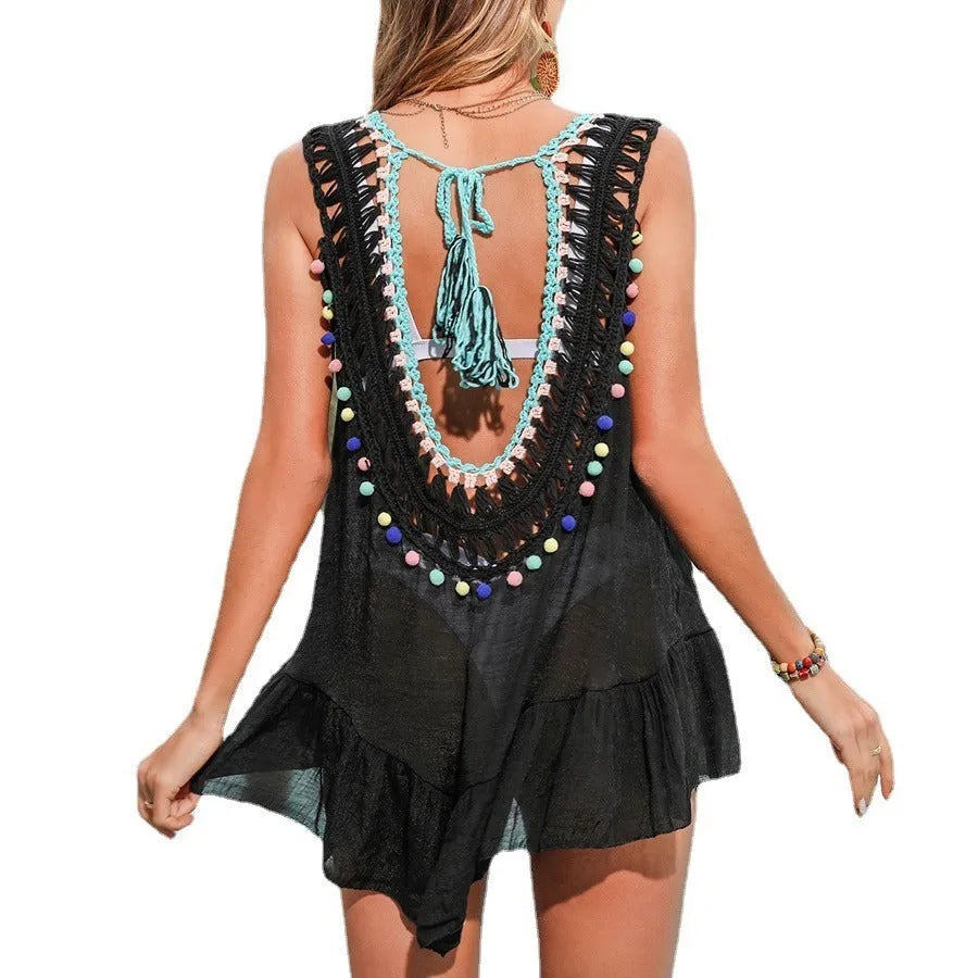 Black hand-crocheted women's beach cover-up vest with ruffle and cut-out details.
