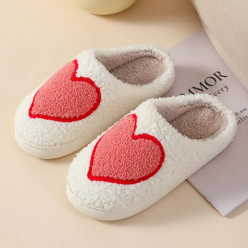 Women's plush cartoon love style home slippers with a round toe and non-slip PVC sole.