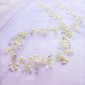Silver wedding hair band with crystal and pearl decoration for long hair styling