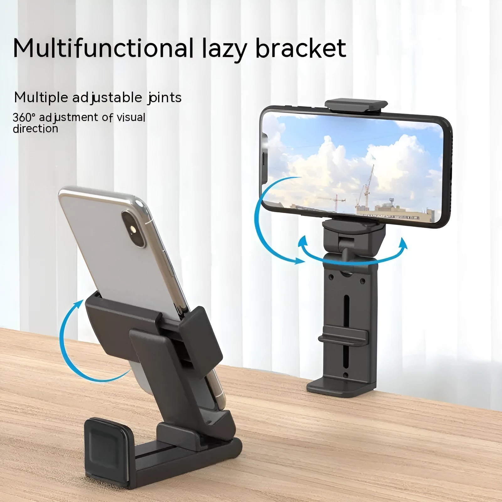 360 rotary collapsible mobile phone holder in black on a desk, with a phone propped up in landscape mode