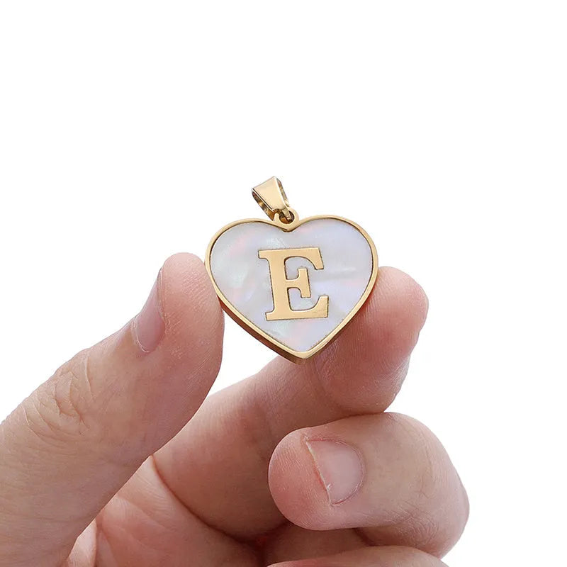 Gold heart-shaped white shell necklace with personalised letter charm on adjustable chain