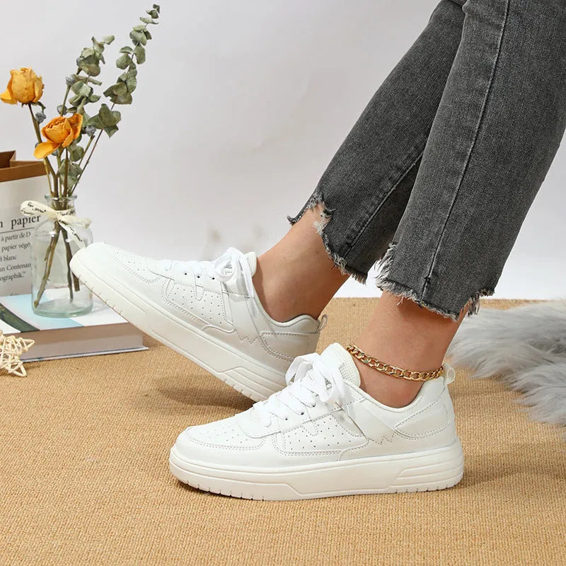 Casual solid colour low top sports shoes with front lace-up, round toe, and metal accents on a white background