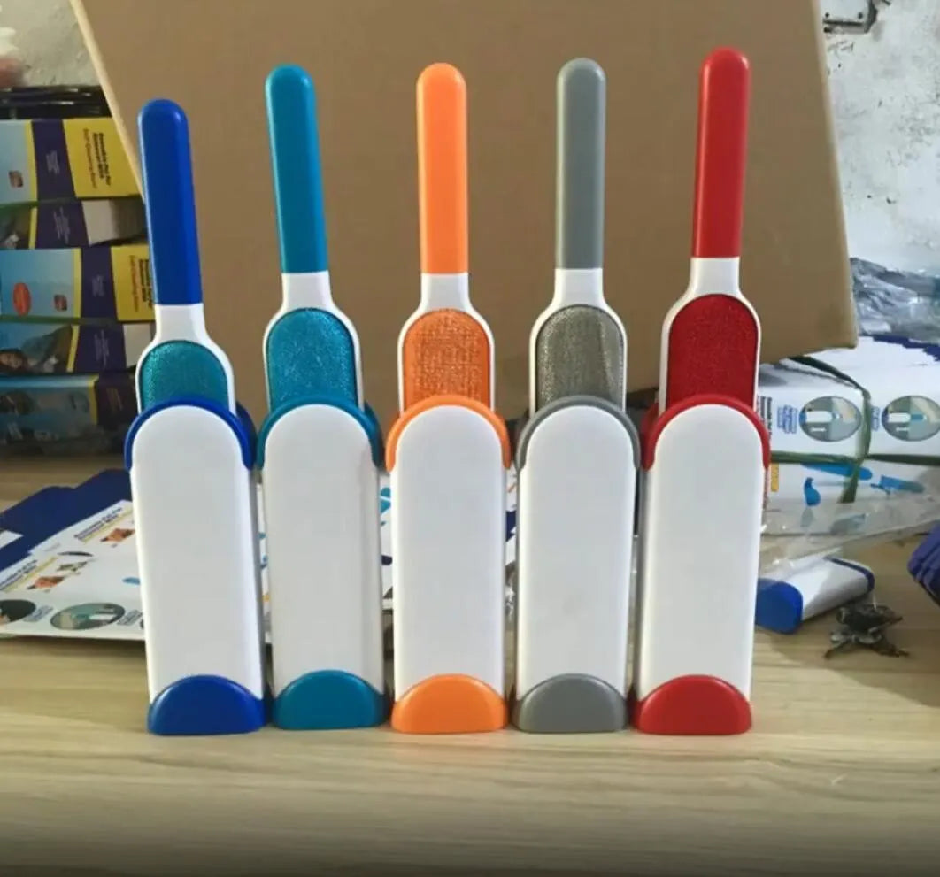 Blue self-cleaning pet hair removal brush for sofas on a grey fabric couch.