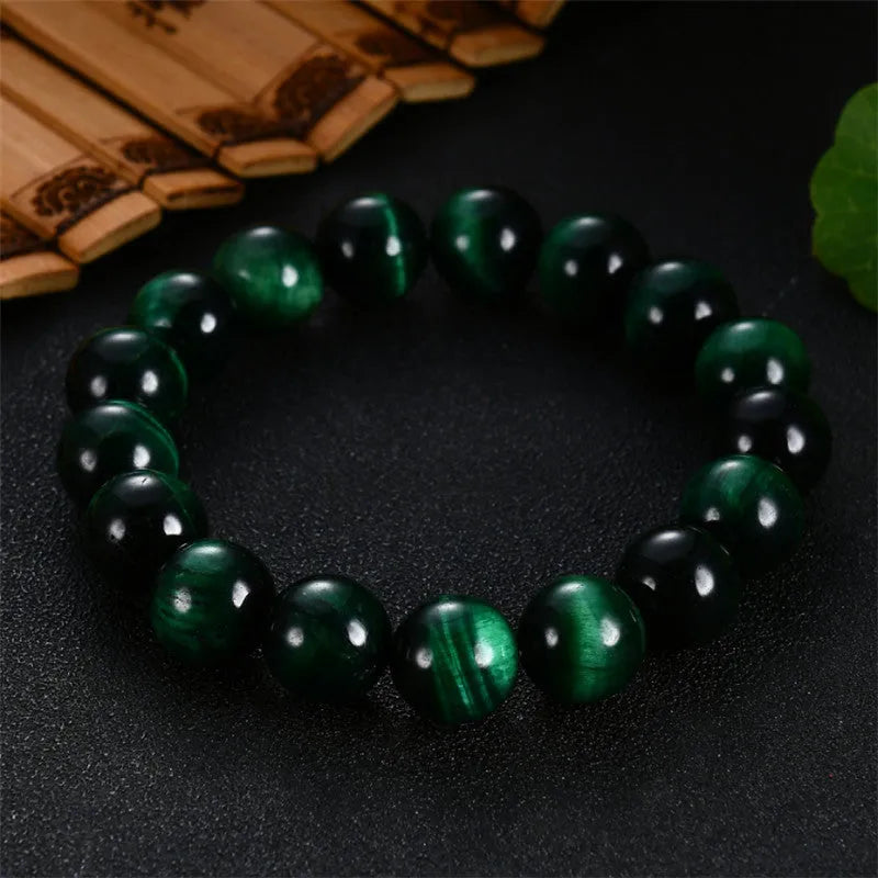 Green tiger eye stone bracelet with polished geometric beads in natural stone material
