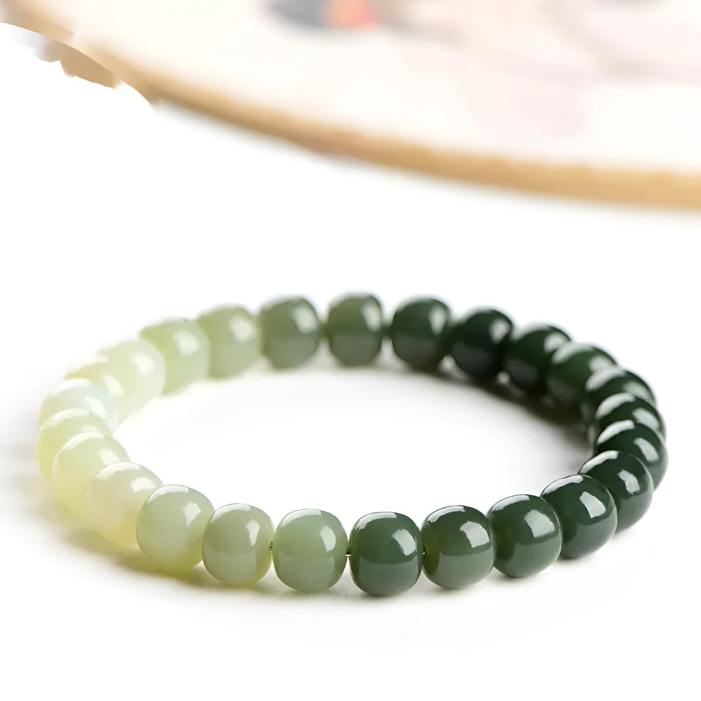 Natural Hetian jade bracelet with clear water gradient on wrist.