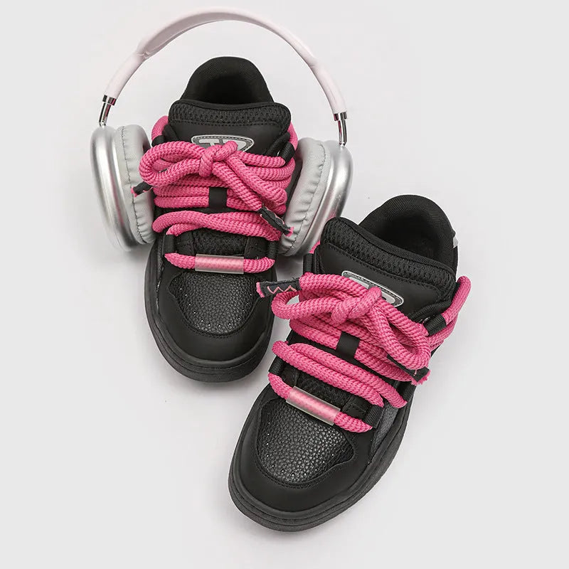 Pair of low-top unisex casual lace-up shoes with a thick rubber sole, shown in a solid colour.