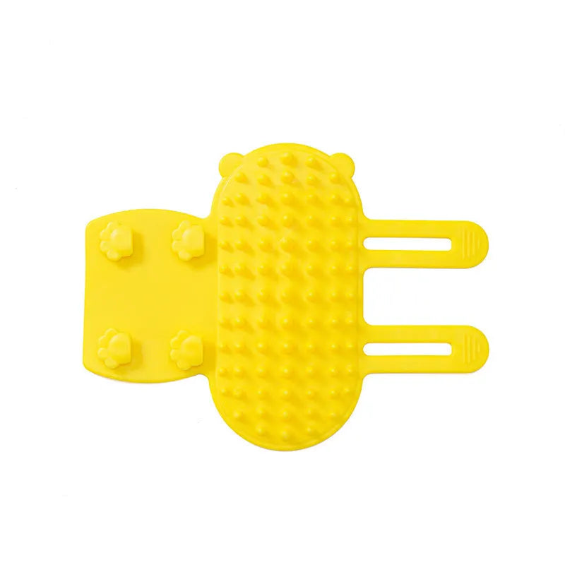 Silicone cat grooming comb with adjustable strap mounted on a table leg