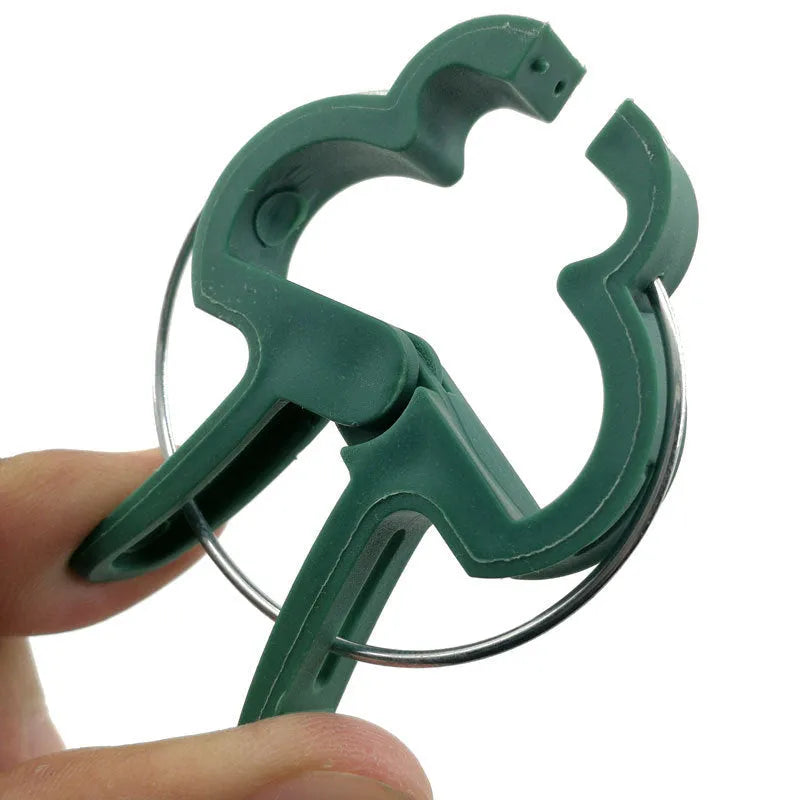Set of green plastic plant fixing clips with zinc springs, showing large and small sizes for garden use.