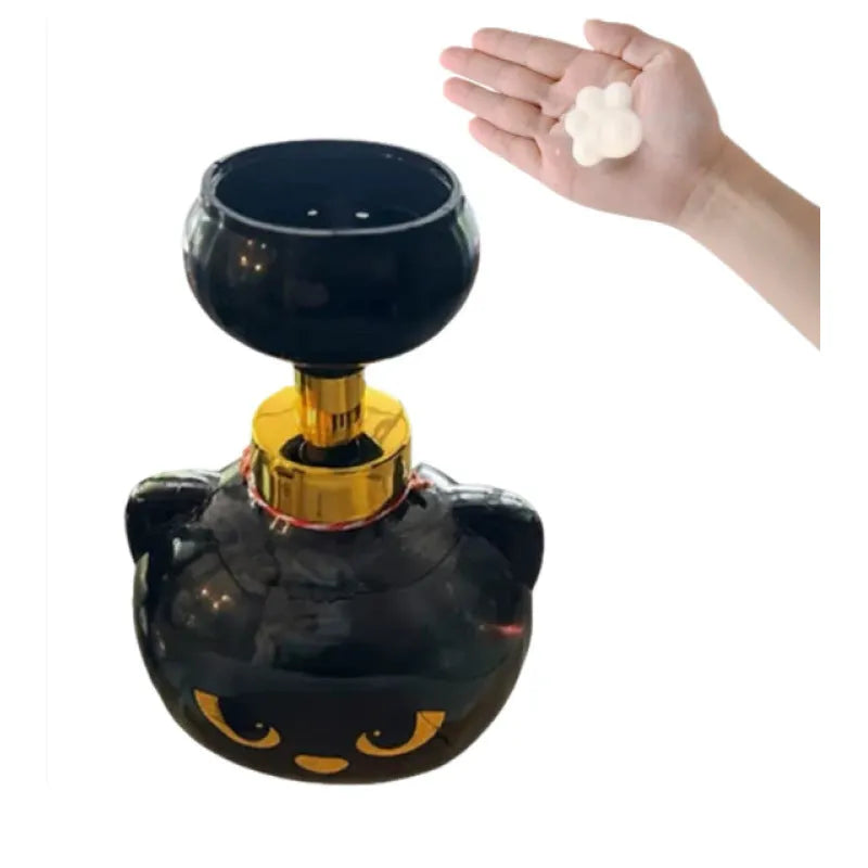 Black plastic cartoon cat-shaped foam soap dispenser on a countertop.