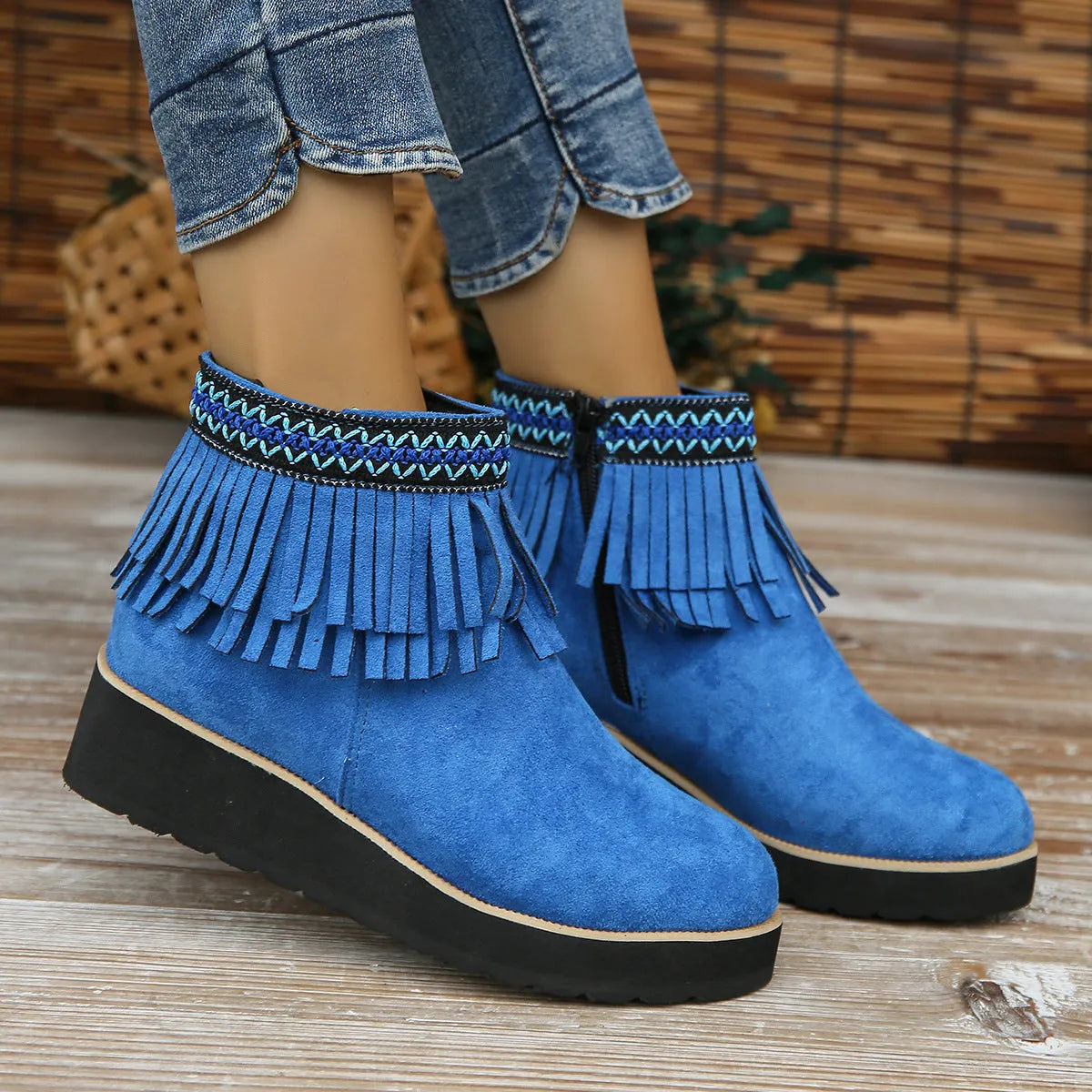 Women's black suede wedge ankle boots with tassel and side zip on a waterproof platform sole.